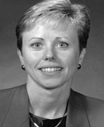 A close-up of a woman smiling, who is a women's basketball hall of fame member.