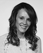 A black and white photo of a woman smiling.