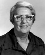 A black and white photo of an older woman wearing glasses.