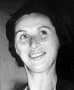 A black and white photo of a woman smiling.