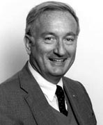 A black and white photo of a man in a suit and tie.