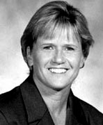 A black and white photo of a woman smiling.