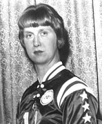 A black and white photo of a woman in a uniform.