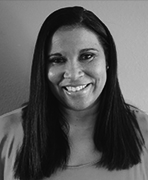 A black and white photo of a woman smiling.