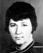 A black and white photo of a woman with short hair.