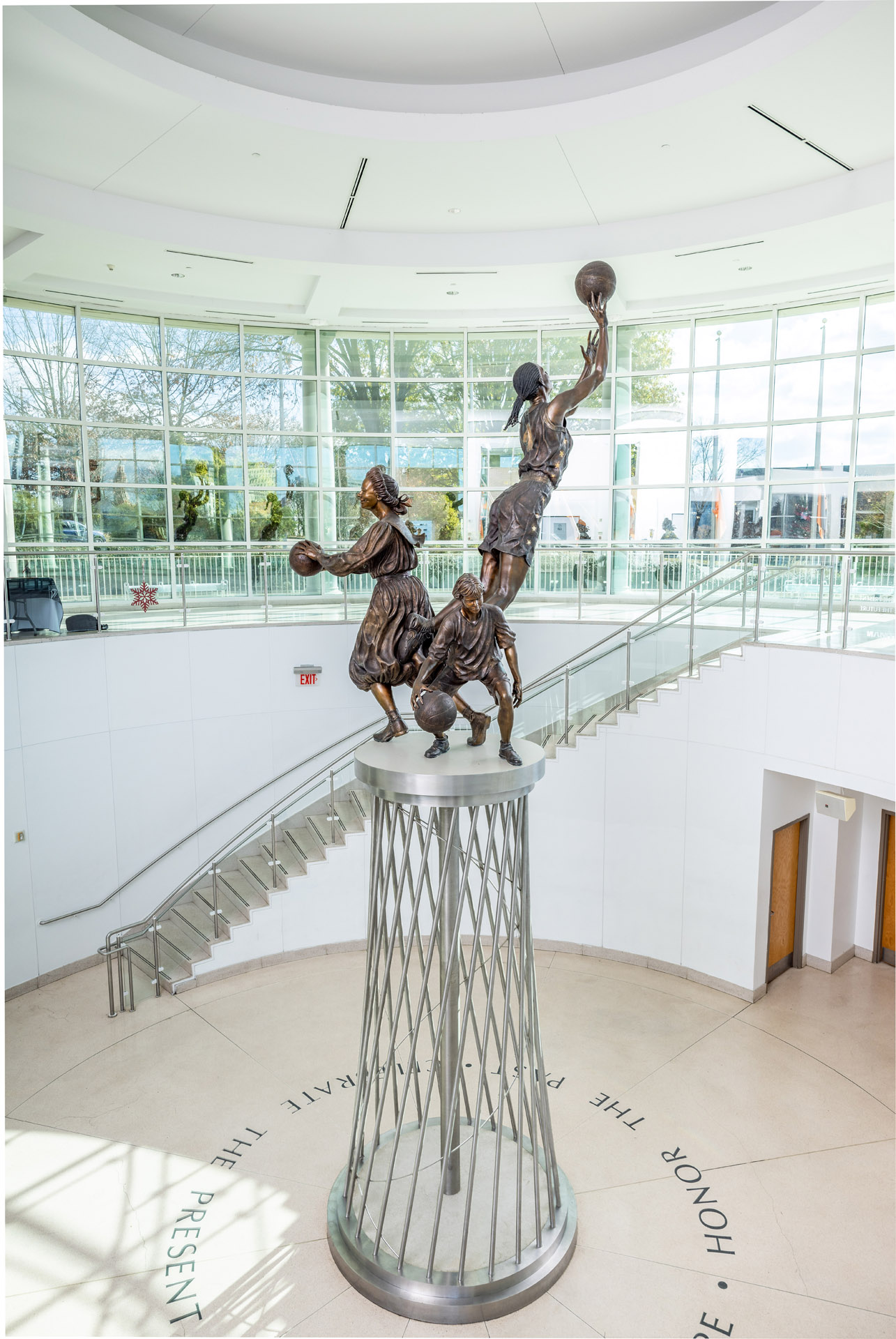 A berenson trophy statue of a basketball player on top of a staircase.