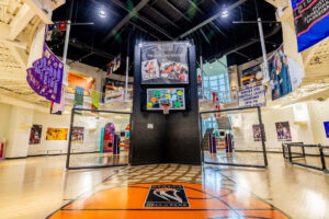 A basketball court in a building with a lot of posters.