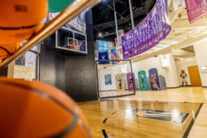 A basketball court with basketballs hanging from the ceiling.