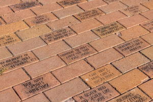 A group of bricks adorned with words, available for donation.